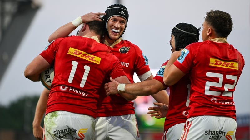Shane Daly (11) is congratulated after scoring Munster's fifth try