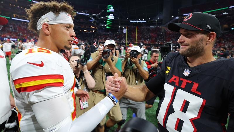 Patrick Mahomes (L) of the Kansas City Chiefs and his quarterback counterpart Kirk Cousins embrace after the game in Georgia
