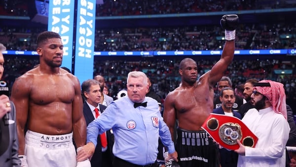 Daniel Dubois raises his hand in victory after stopping Anthony Joshua in September