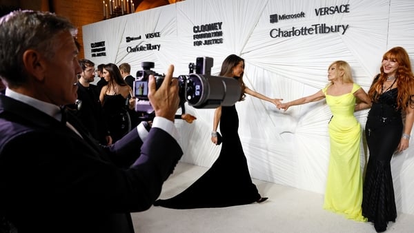 George Clooney borrows photographer Michael Stewart's camera in order to take photos of Amal Clooney, Donatella Versace, and Charlotte Tilbury