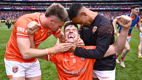Niall Grimley (c) celebrates with team-mates Greg McCabe, left, and Jemar Hall after Armagh's All-Ireland triumph