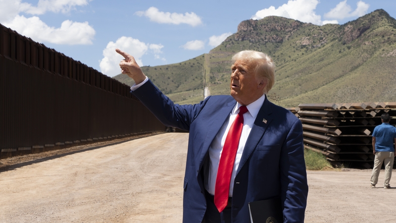 Republican presidential candidate and former US president Donald Trump walks along the U.S.-Mexico border Photo: Rebecca Noble/Getty Images