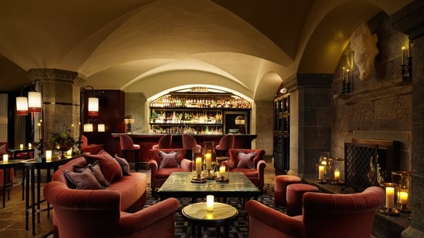 The Tack Room, a cosy bar filled with candle light and red sodas located in underground at Adare Manor, Co Limerick