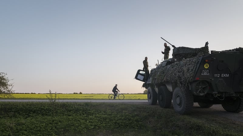 Estonian soldiers chatting with a local during a training exercise last year in Kadrina, northern Estonia
