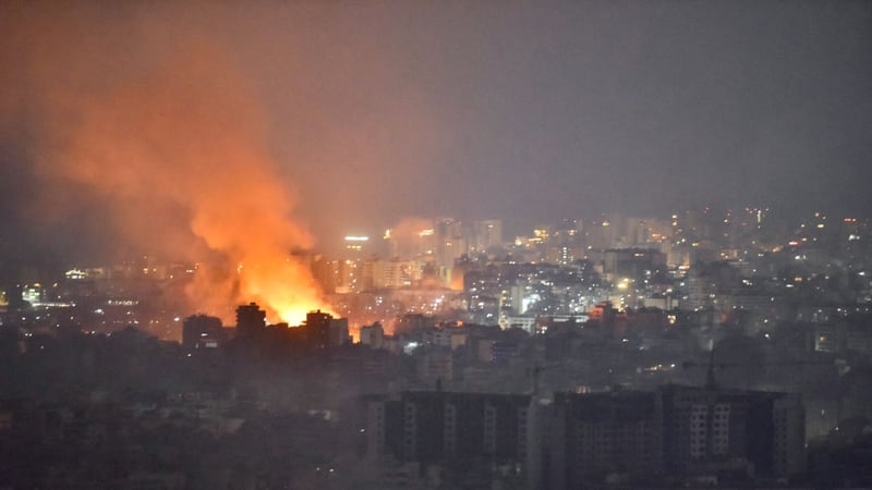 Flames and smoke rise in an area targeted by an Israeli air strike on Beirut's southern suburbs