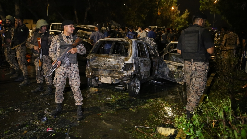 Soldiers secure the site of a massive explosion which targeted a convoy of Chinese nationals in Karachi