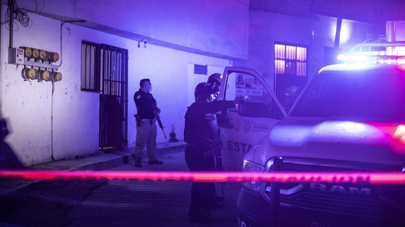 Investigators and forensic personnel work at the crime scene where remains of Alejandro Arcos were found