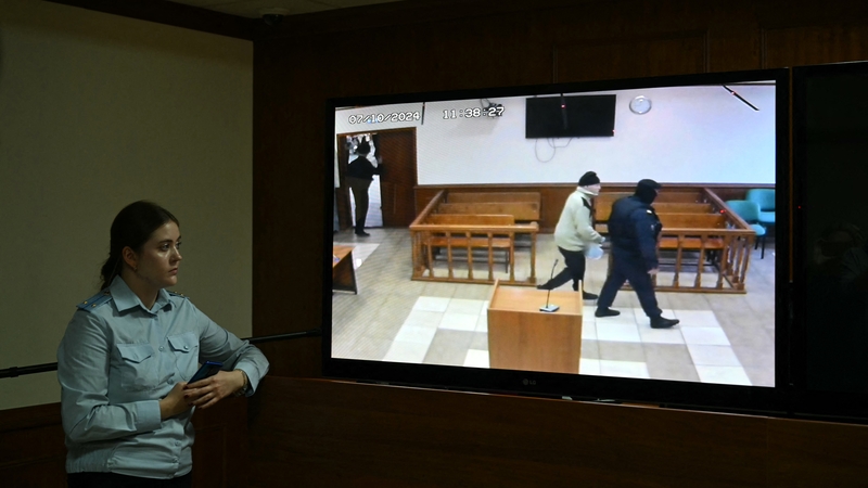 The defendant dressed in a knitted jacket and dark trousers shuffled slowly into court