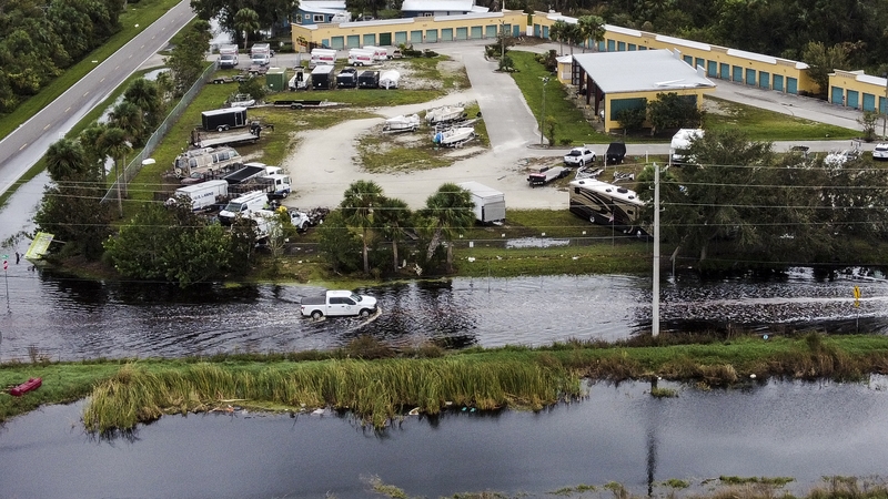 A car driving on a flooded street after Hurricane Milton in Punta Gorda