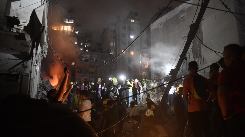 People conduct searches in the aftermath of an Israeli strike on the Nowayri neighburhodd of Beirut in Lebanon