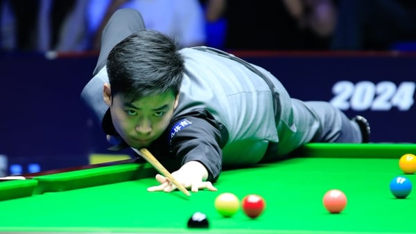 Si Jiahui plays a shot in the semi-final win over Judd Trump