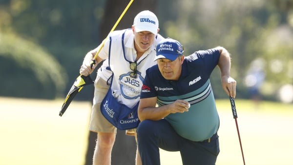 Pádraig Harrington (right) and caddie Ronan Flood line up a putt in the final round