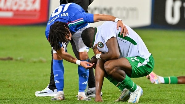 A dejected Sinclair Armstrong is consoled by Italy's Luca Koleosho