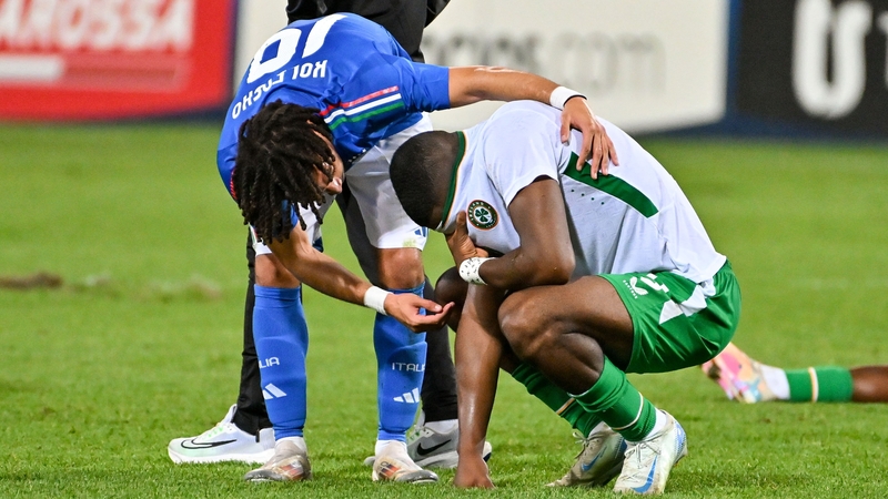 A dejected Sinclair Armstrong is consoled by Italy's Luca Koleosho