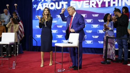 Donald Trump dancing to the song 'YMCA' with South Dakota Governor Kristi Noem during a town hall event in Pennsylvania