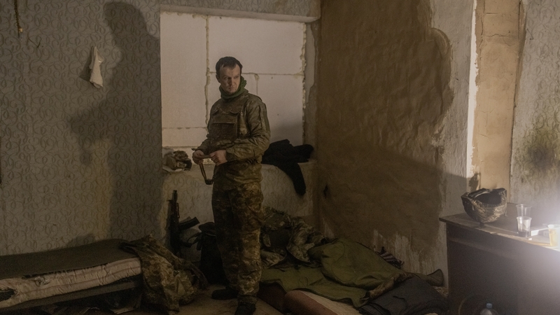 A Ukrainian serviceman of the 110th Mechanised Brigade stands in a house converted to a military place near the border line of the town of Kurakhove
