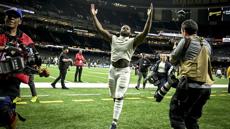 Javonte Williams of the Denver Broncos salutes the fans as he leaves the field