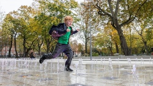 Mary Lavin's great-grandson Nicholas Foley running through a water feature at Mary Lavin Place