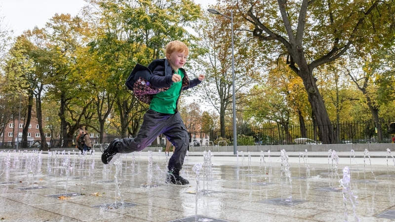Mary Lavin's great-grandson Nicholas Foley running through a water feature at Mary Lavin Place