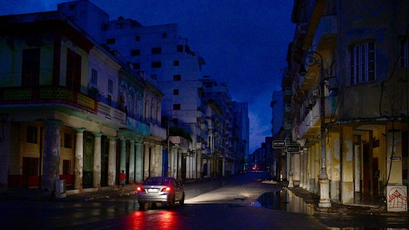 A car drives along a street during a nationwide blackout caused by a grid failure in Havana