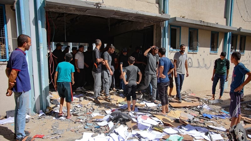 Palestinians check the damage in a UN school-turned-refuge in the Al-Shati refugee camp near Gaza City