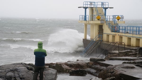 A person watches the waves at Blackrock diving tower in Salthill, Galway