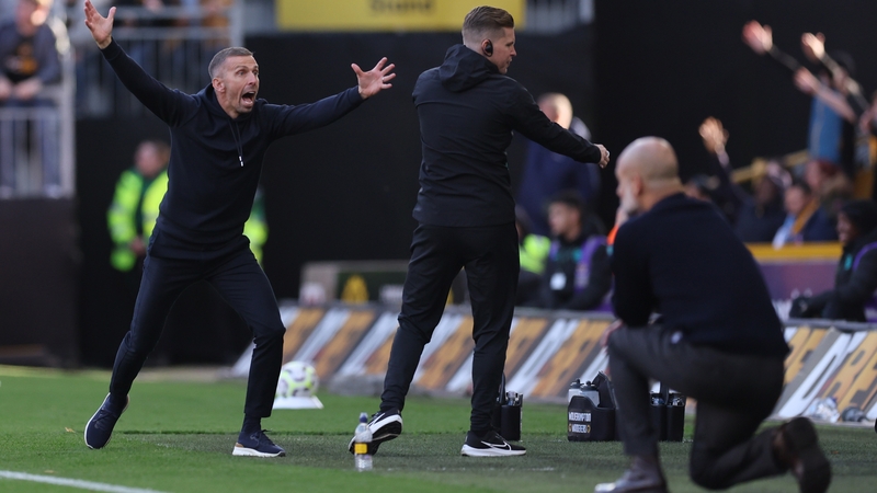 O'Neil (L) reacts as Guardiola watches on