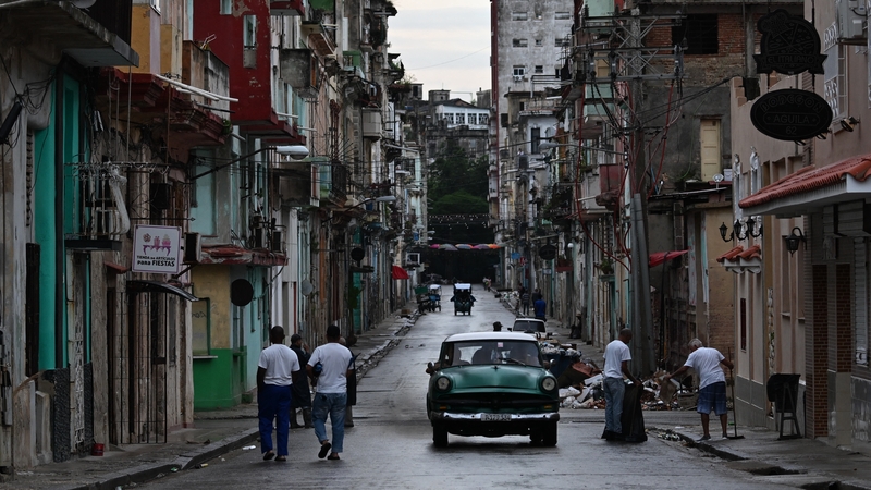 People walk along a street in Havana during the fourth day of a massive power outage in Cuba