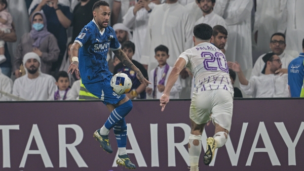 Neymar (L) on the ball against Matias Palacios of Al-Ain