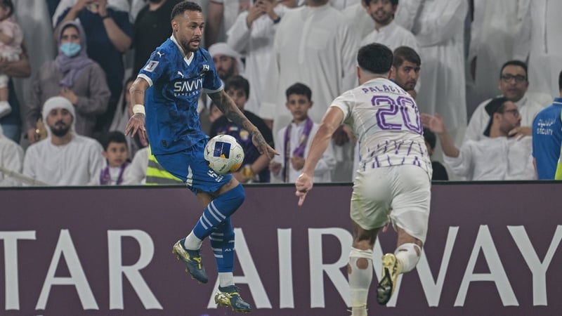 Neymar (L) on the ball against Matias Palacios of Al-Ain