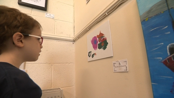 Oisin looking at his art!