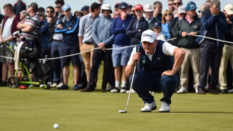 Fans watch R&A Amateur champion James Sugrue line up a putt at Portmarnock Golf Club in 2019