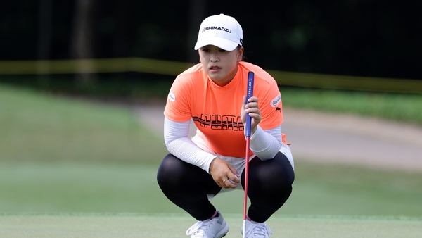 Mao Saigo of Japan lines up a putt on the third green