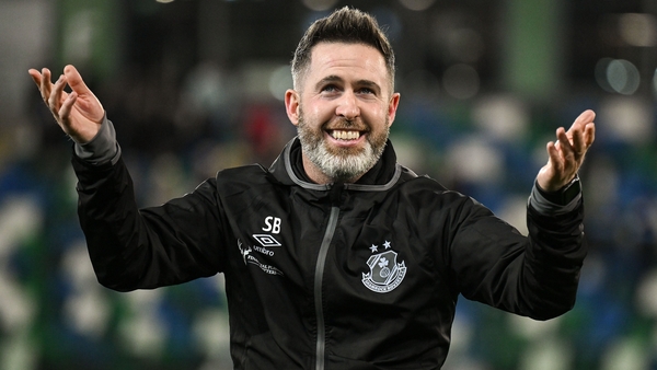 Stephen Bradley celebrates with the travelling fans after the Windsor Park victory