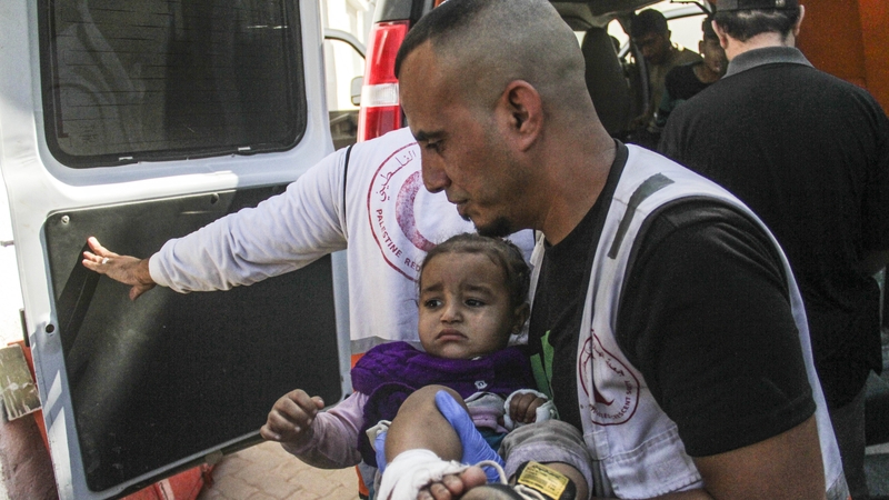 An injured baby is brought to al-Ahli Baptist Hospital in Gaza City following an Israeli strike on Jabalia refugee camp