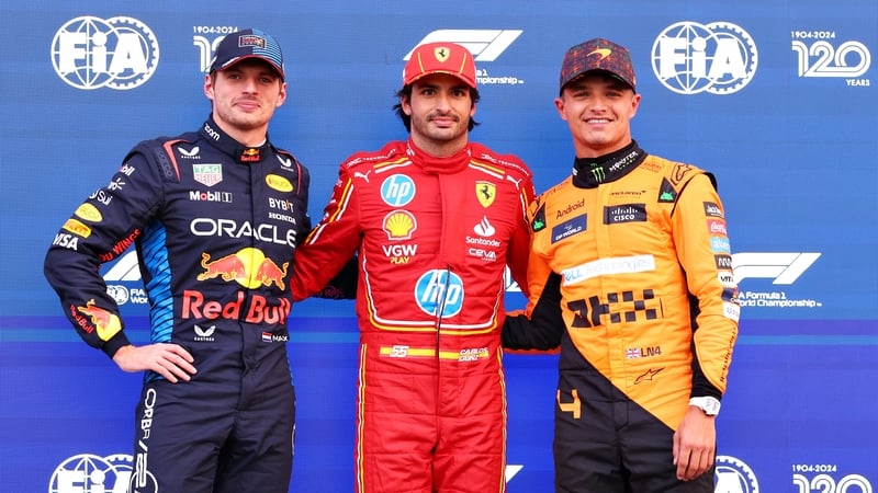 Pole position qualifier Carlos Sainz with Max Verstappen and Lando Norris (r) either side of him