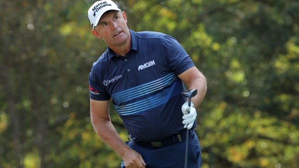 Harrington watches his tee shot on the fourth hole