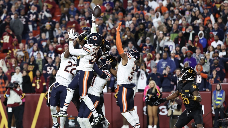 Noah Brown (R) awaits in the end zone as Jayden Daniels' Hail Mary pass arrives