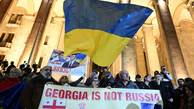 Georgians rally to protest results of the parliamentary elections outside the parliament building