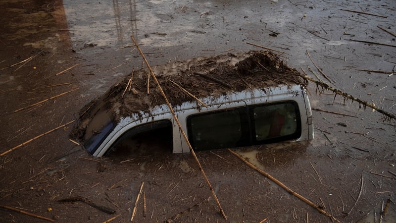 A car covered with mud on a flooded street in Alora, near Malaga