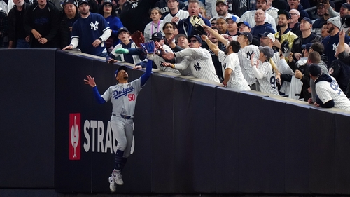 Gleyber Torres was given out after a fan in a Yankees top took the ball from the glove of Dodgers outfielder Mookie Betts