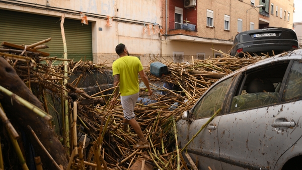 A street in Valencia was buried in debris and damaged vehicles