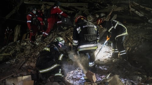 Rescue workers conduct a search and rescue operation amid rubble of a house destroyed by Russian shelling yesterday