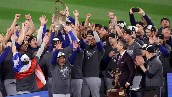 The Los Angeles Dodgers celebrate with the Commissioner's Trophy