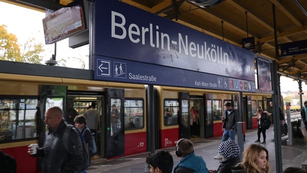 People board an S-Bahn commuter train at Neukölln station in Berlin