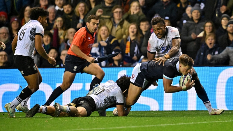 Scotland's centre Huw Jones dives to score a try