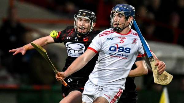 Chris Thomas of Doon (R) is tackled by Ballygunner's Pauric Mahony
