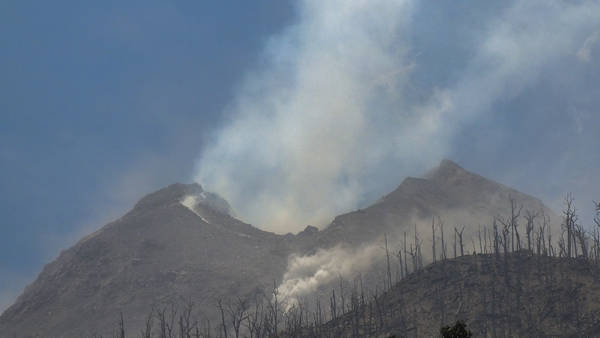 Smoke billows from Mount Lewotobi Laki-Laki as seen from Klatanlo village