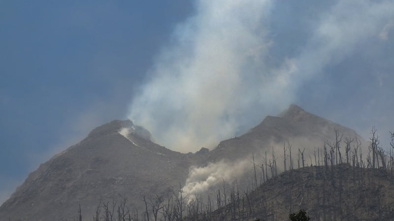Smoke billows from Mount Lewotobi Laki-Laki as seen from Klatanlo village