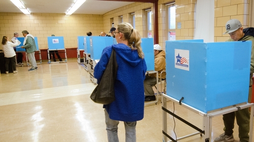 People cast their votes during early voting for the Presidential General Election at polling station in Chicago, Illinois